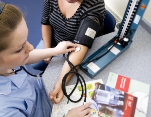 Nurse checking patient's blood pressure from imagequest